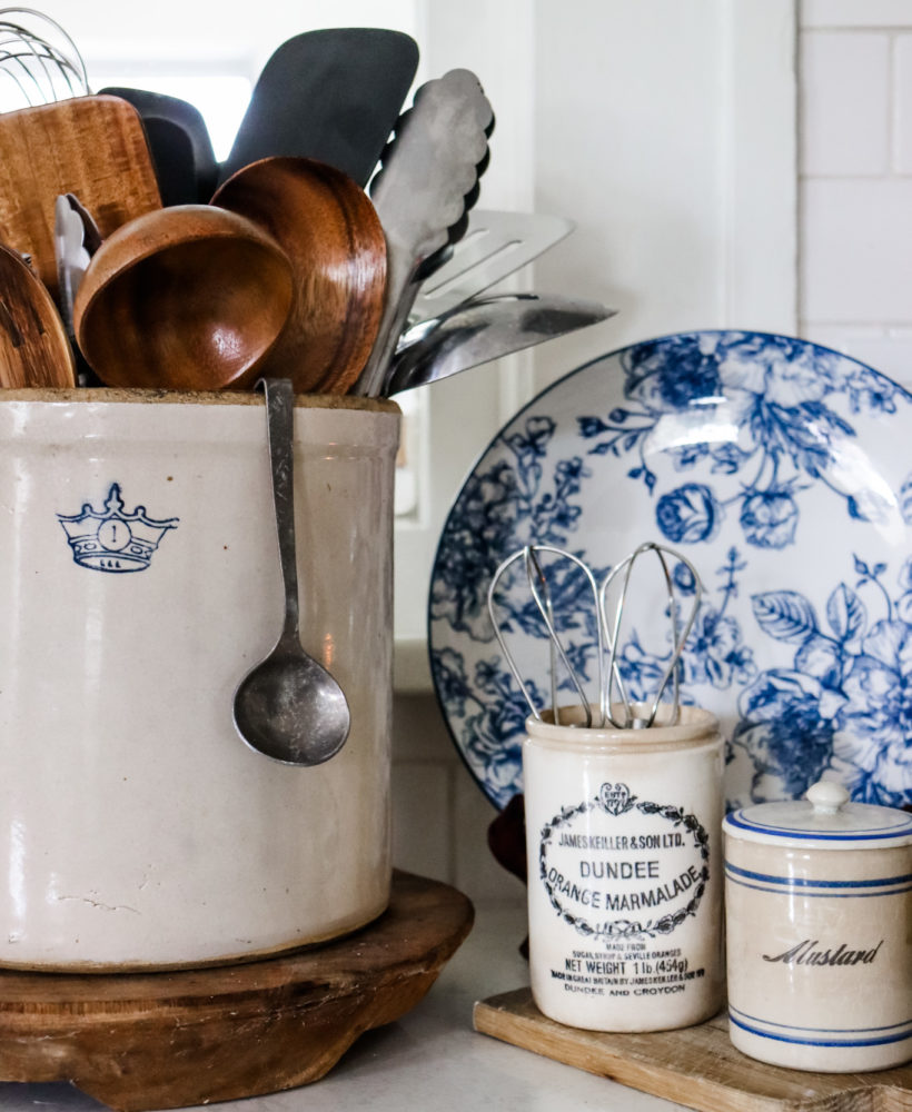 Vintage crock and marmalade jar are stylish organization options in a kitchen.